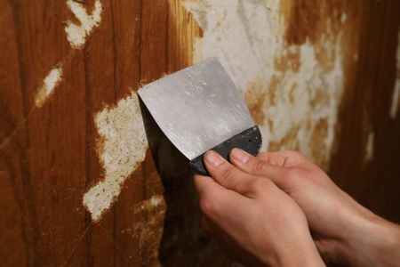 Remove adhesive residue from wall